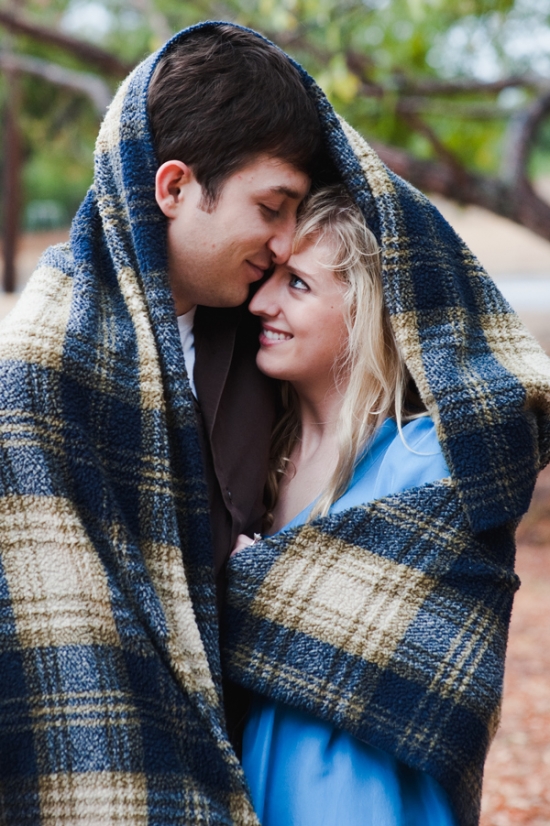 Romantic Couple Cuddles Under Plaid Blanket