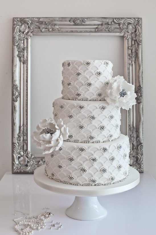 Elegant White Wedding Cake with Floral Details by Sugar Ruffles