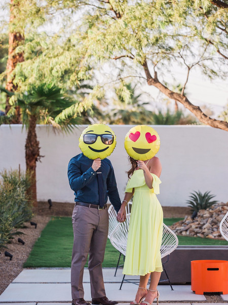 Cute Engagement Photo Idea: Emoji Balloons and Smiling Couple