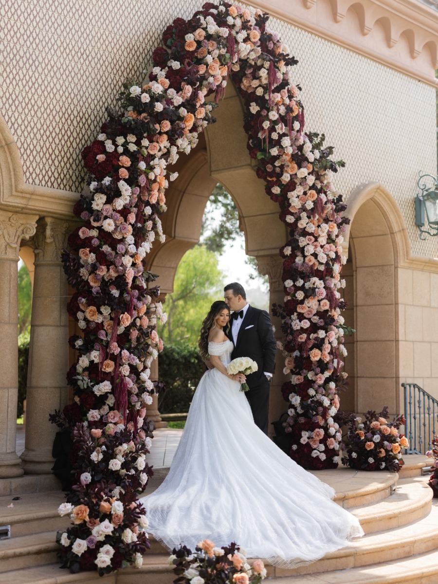 The floral arch fused with the venue in this elegant persian wedding