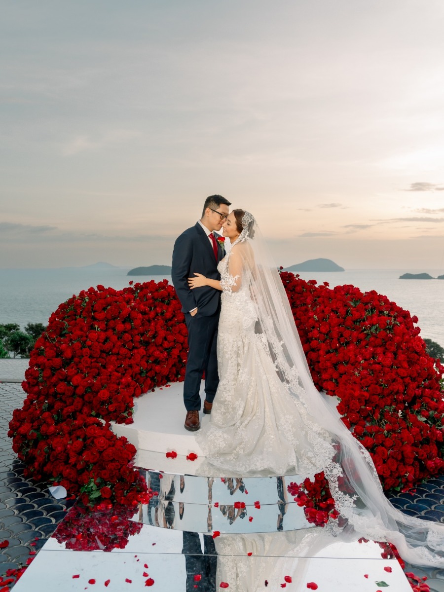 Red rose themed wedding with a dramatic aisle overlooking Phuket