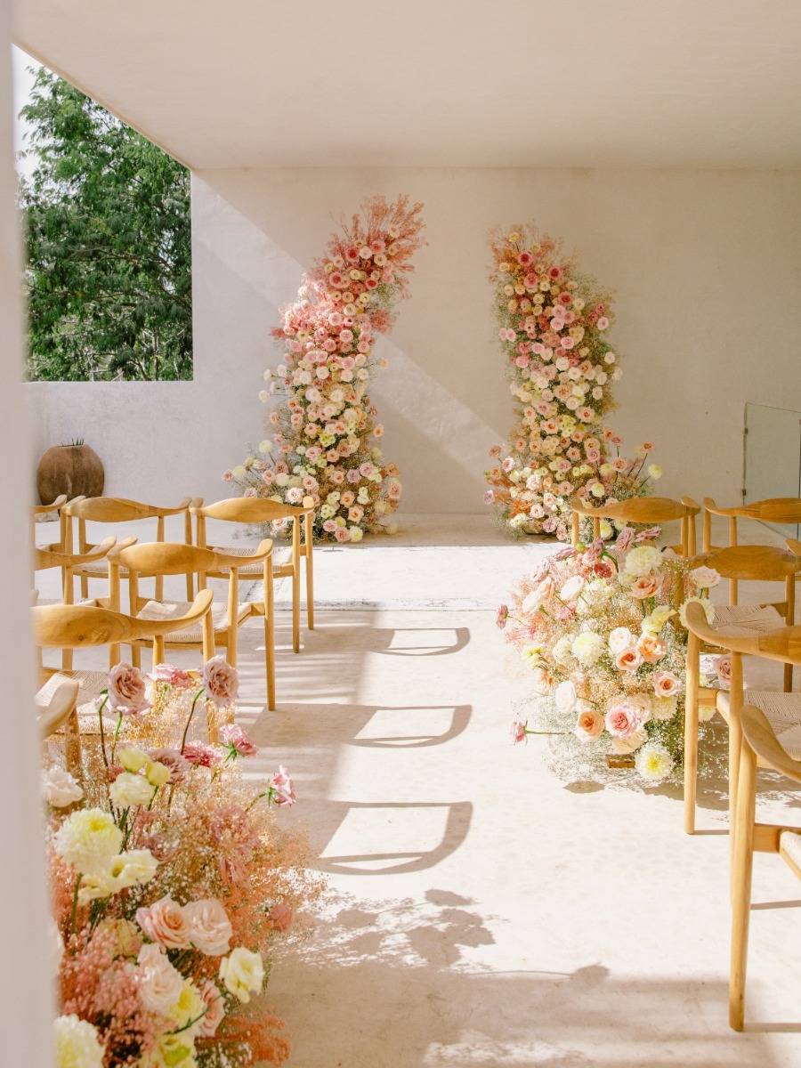 Luxury destination wedding in tulum with a peach ombre floral arch