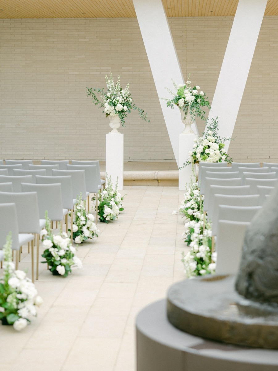 A modern museum wedding in arkansas with an antique getaway car