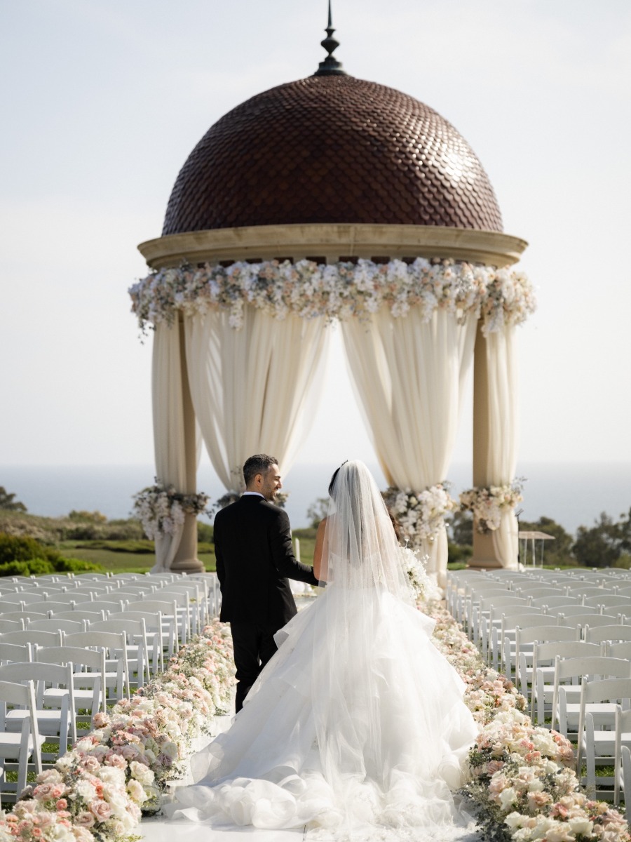 $360,000 coastal wedding framed in floor-to-ceiling blush florals