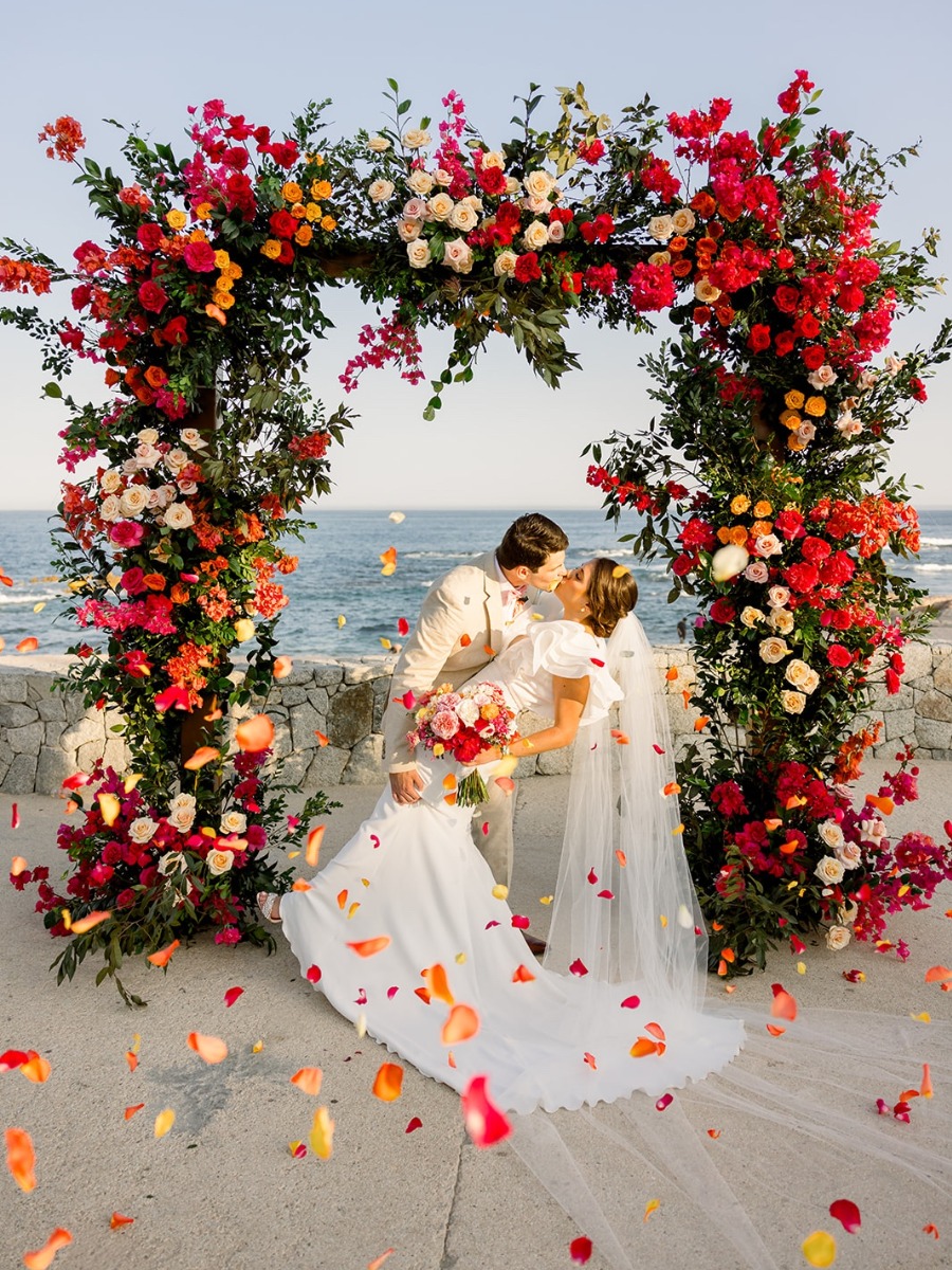 Vibrant beach wedding in cabo san lucas with a citrus color palette
